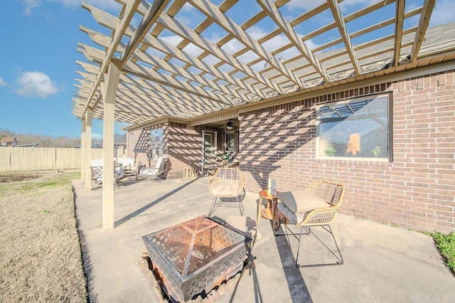 view of patio with a pergola and a fire pit