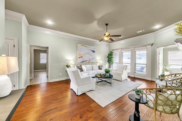 living room featuring ornate columns, ceiling fan, hardwood / wood-style flooring, and ornamental molding