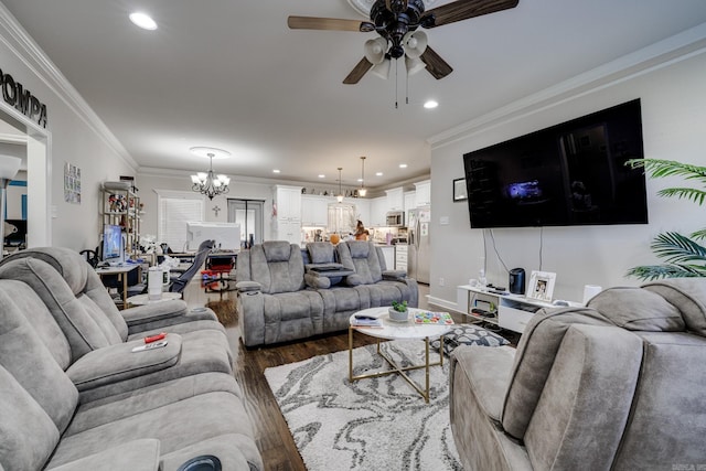 living room featuring ceiling fan with notable chandelier, crown molding, and dark hardwood / wood-style floors