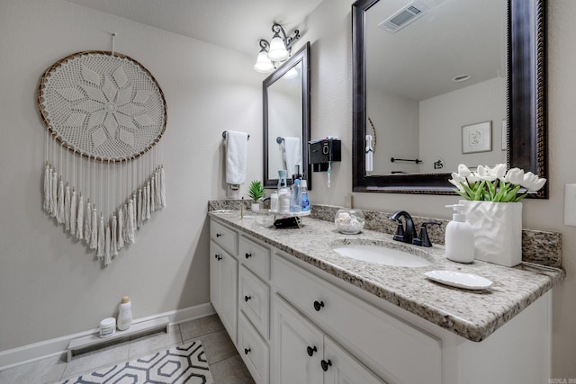 bathroom with tile patterned floors and vanity