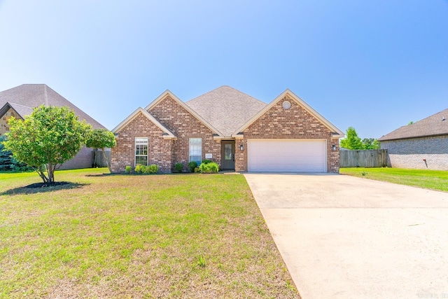 view of front of property with a front yard and a garage