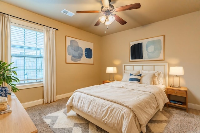 bedroom featuring multiple windows and ceiling fan