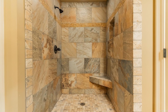 interior details with a tile shower