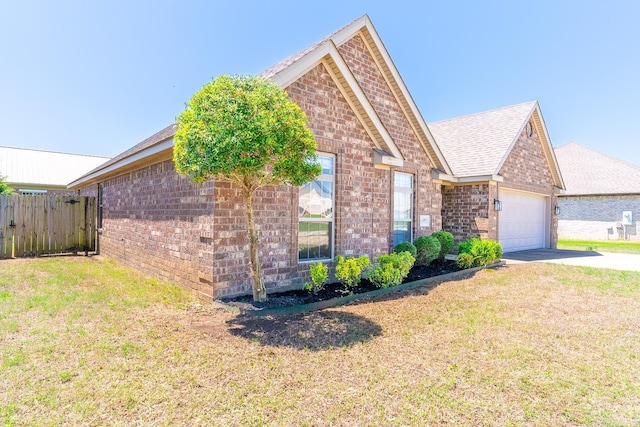 view of front of property with a garage and a front lawn