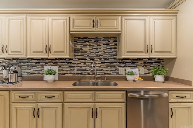 kitchen with cream cabinetry, dishwasher, decorative backsplash, and sink