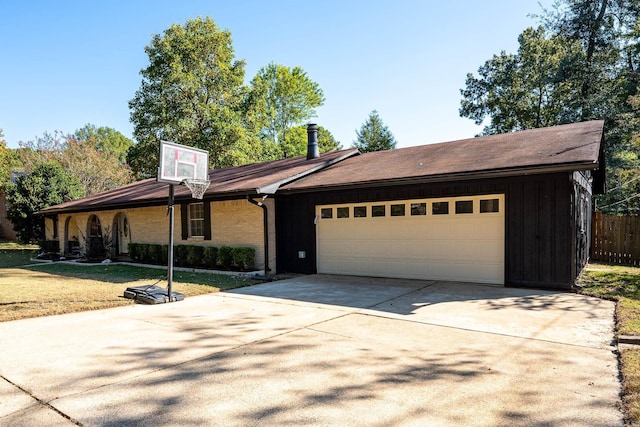 ranch-style home featuring a front yard and a garage