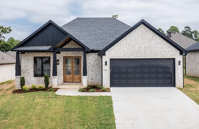 view of front of home with a garage and a front lawn