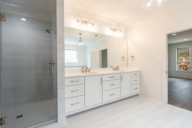 bathroom with vanity, an enclosed shower, and ornamental molding