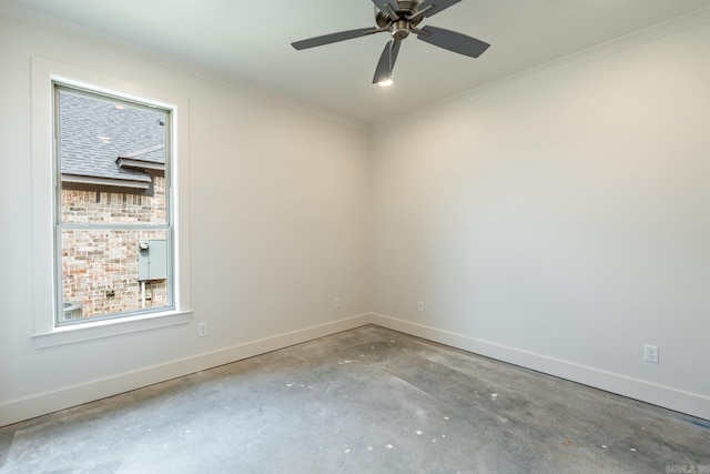 spare room featuring concrete flooring, ceiling fan, and crown molding