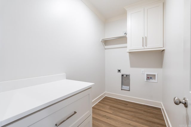 washroom featuring hardwood / wood-style floors, cabinets, crown molding, washer hookup, and hookup for an electric dryer