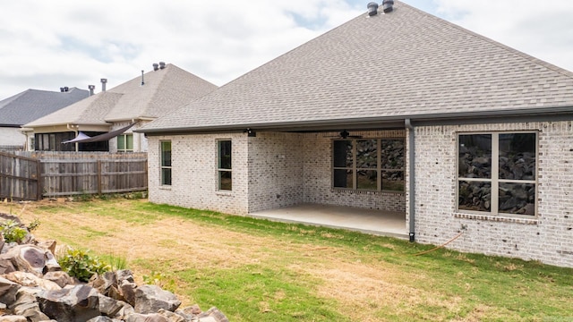 back of property featuring a patio area and a lawn