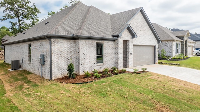 view of home's exterior with a lawn, central AC unit, and a garage