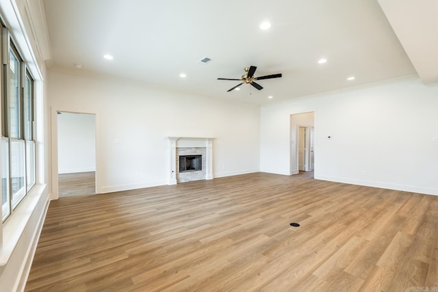 unfurnished living room with ceiling fan, light hardwood / wood-style floors, and ornamental molding