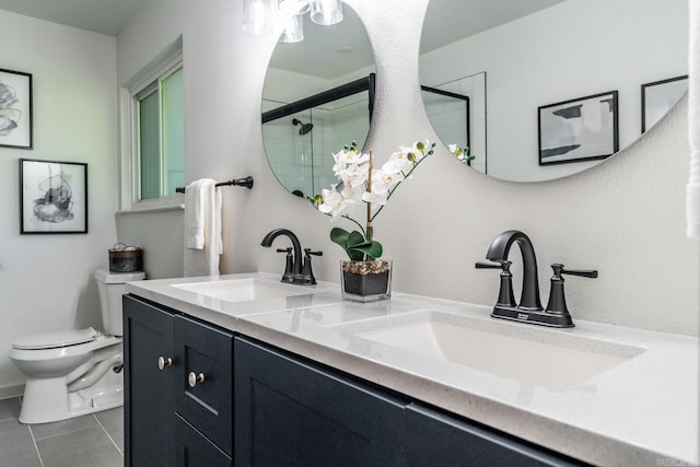 bathroom featuring tile patterned floors, vanity, toilet, and a shower with shower door