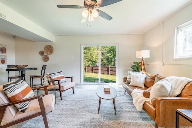 carpeted living room featuring ceiling fan