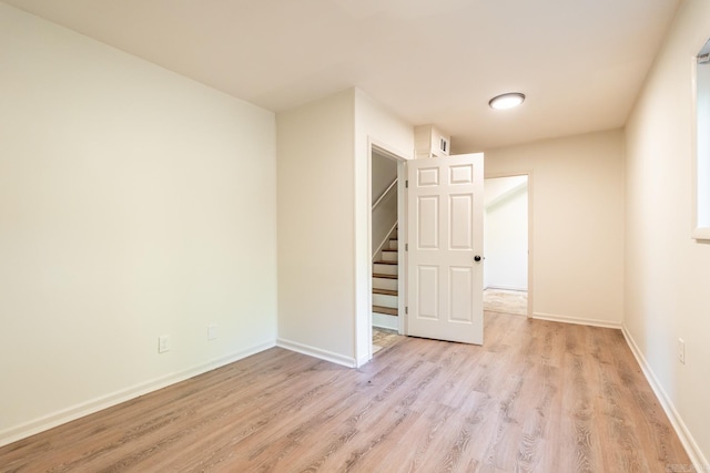 unfurnished room with light hardwood / wood-style flooring