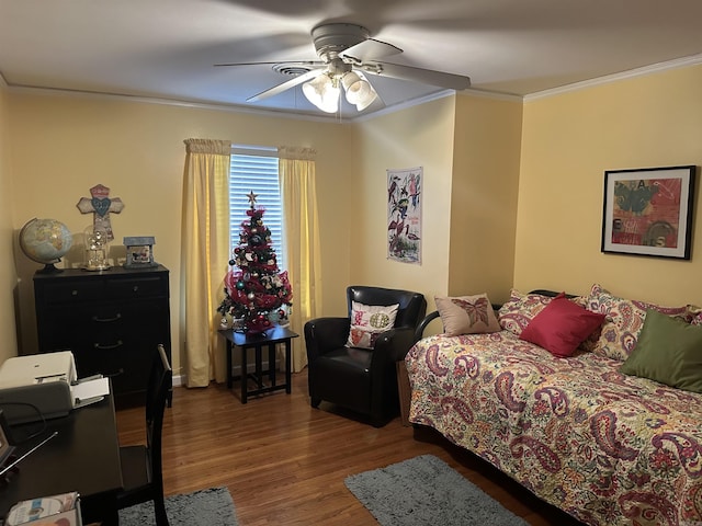 bedroom with ceiling fan, hardwood / wood-style floors, and crown molding