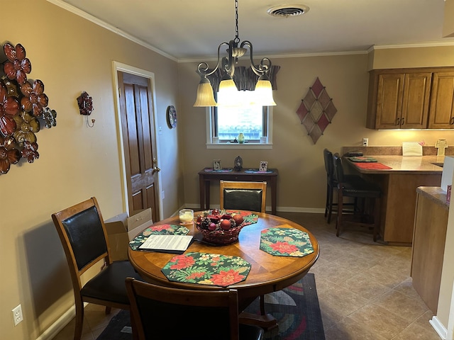 dining space with light tile patterned flooring, ornamental molding, and a notable chandelier