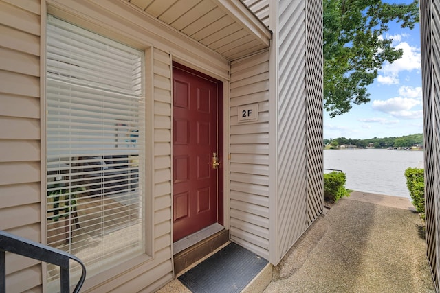 view of exterior entry with a water view