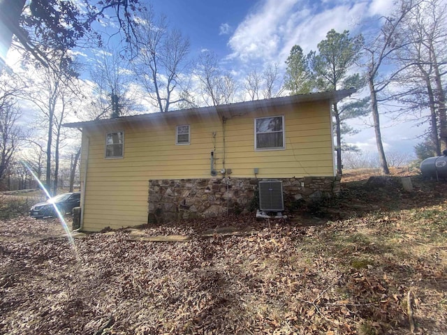 view of side of home featuring central AC