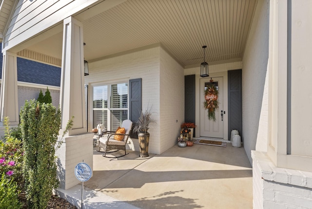 view of exterior entry with covered porch