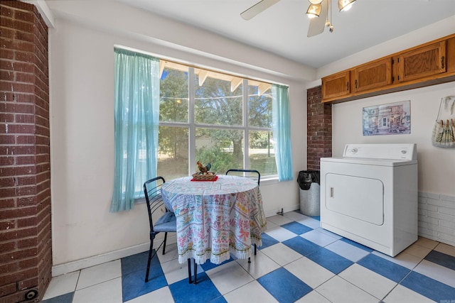 laundry area with ceiling fan, light tile patterned floors, and washer / dryer