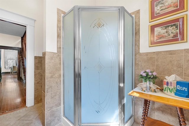 interior space featuring tile patterned floors and tile walls