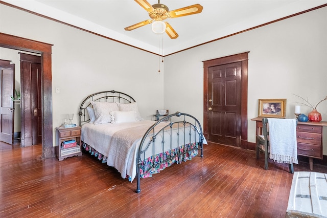 bedroom featuring wood-type flooring, ceiling fan, and crown molding