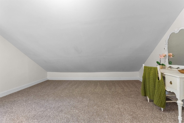 interior space featuring carpet flooring and vaulted ceiling