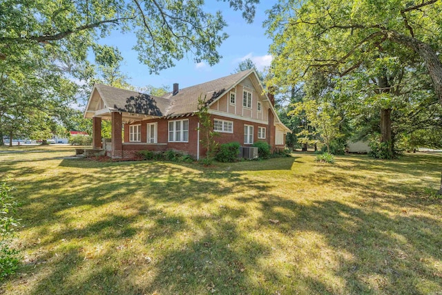 view of property exterior with a lawn and central AC unit