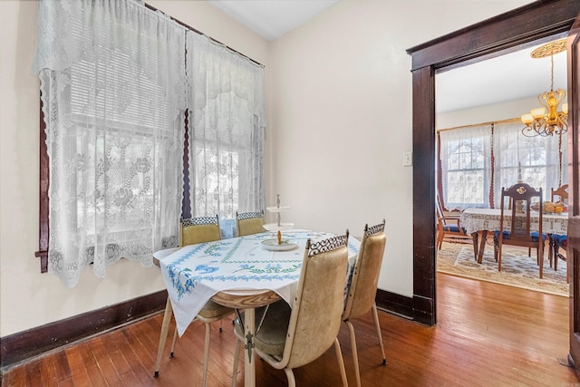 dining area with a chandelier and hardwood / wood-style flooring