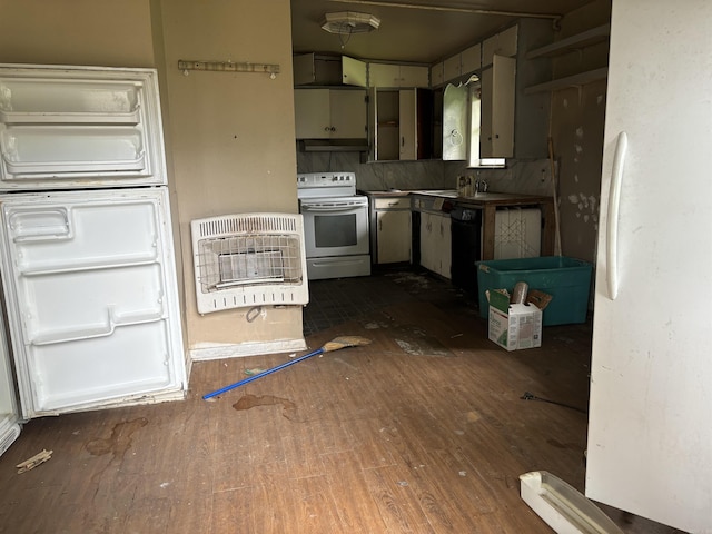 kitchen featuring dark hardwood / wood-style flooring, white appliances, backsplash, and heating unit