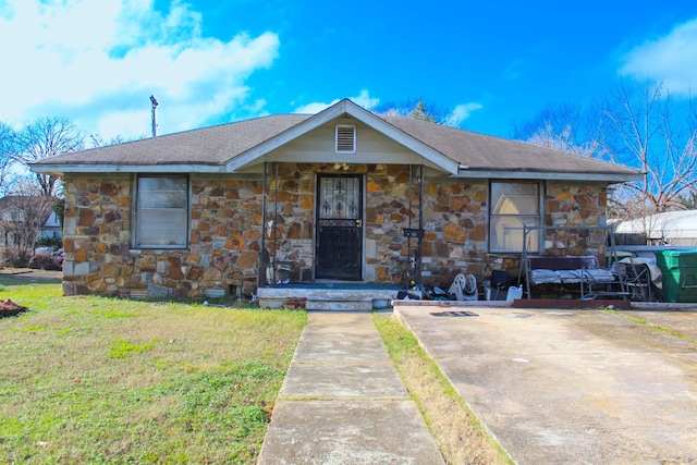 view of front facade with stone siding and a front lawn