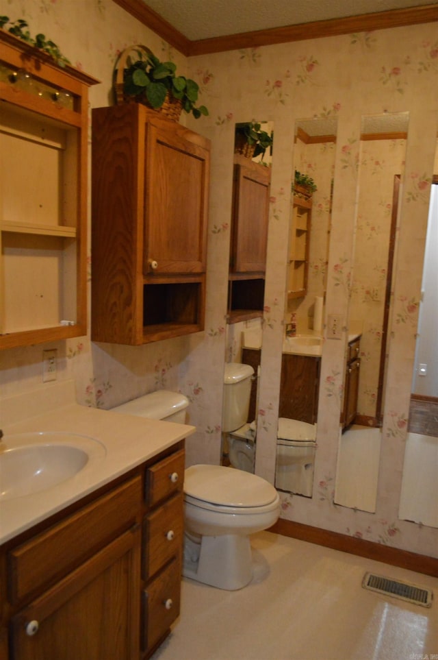 bathroom featuring vanity, toilet, and ornamental molding