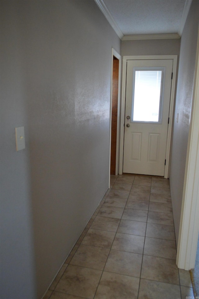 entryway featuring crown molding and light tile patterned floors