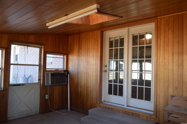 doorway featuring carpet flooring, wood walls, cooling unit, and wood ceiling