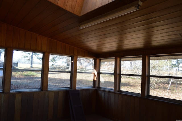 unfurnished sunroom featuring lofted ceiling and wood ceiling