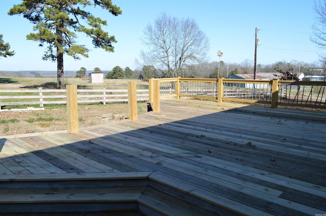 wooden terrace featuring a rural view