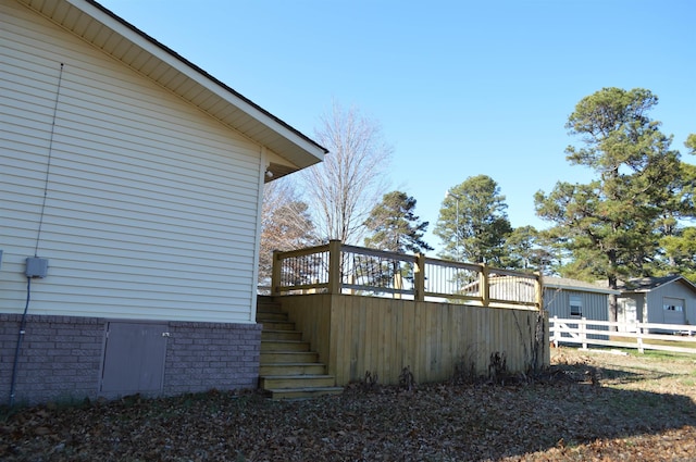 view of side of property with a wooden deck