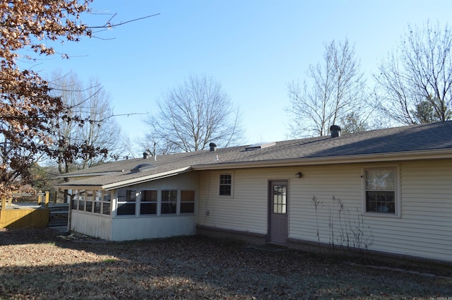 rear view of property with a sunroom