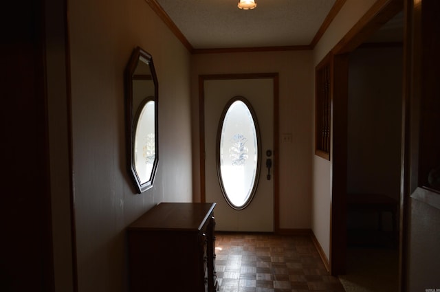 entryway featuring dark parquet flooring, a textured ceiling, and ornamental molding