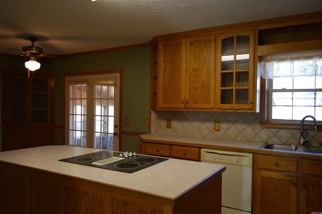 kitchen featuring black electric stovetop, dishwasher, a center island, and sink