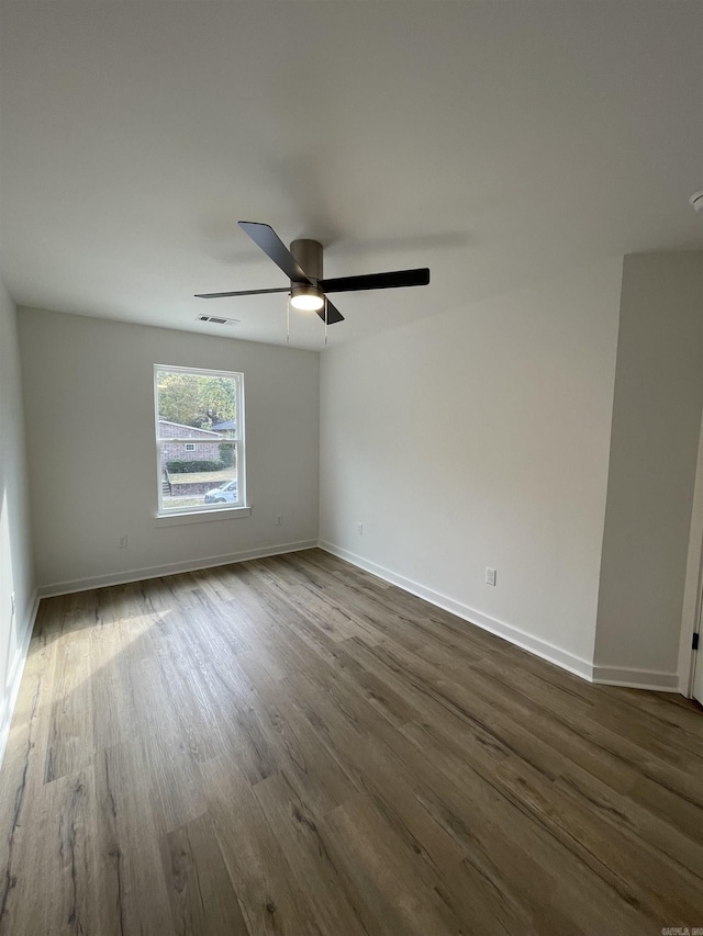 spare room featuring hardwood / wood-style floors and ceiling fan