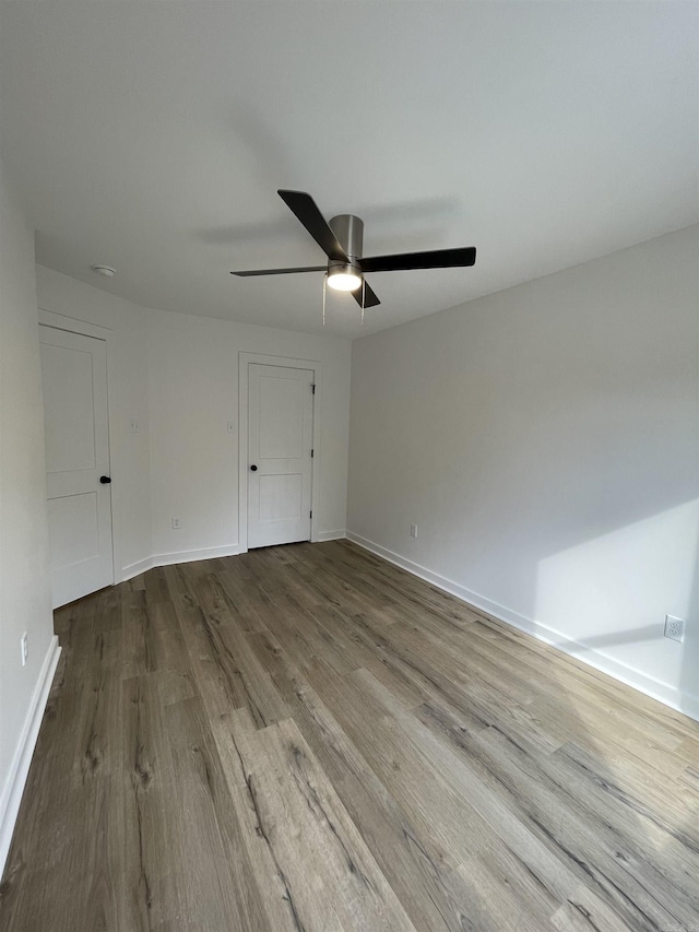 unfurnished room with ceiling fan and light wood-type flooring