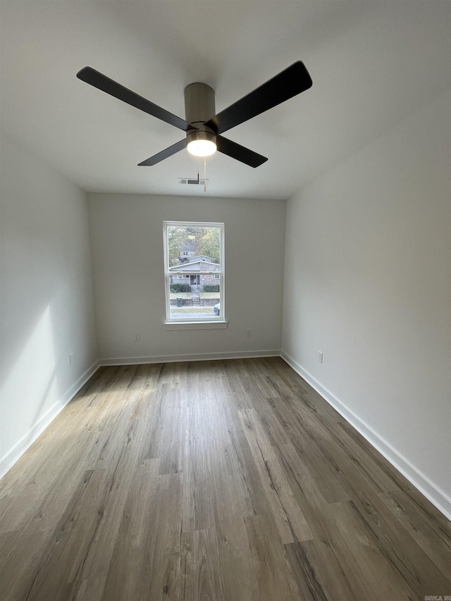 empty room featuring light hardwood / wood-style flooring and ceiling fan