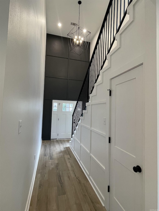 interior space with hardwood / wood-style flooring and an inviting chandelier