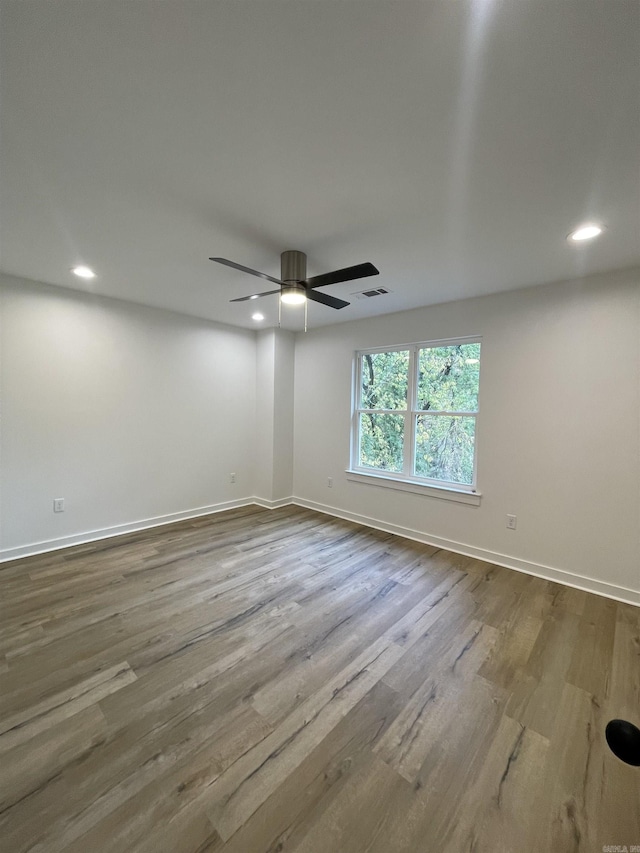 spare room featuring hardwood / wood-style floors and ceiling fan