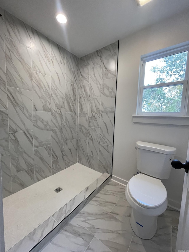 bathroom featuring toilet and tiled shower