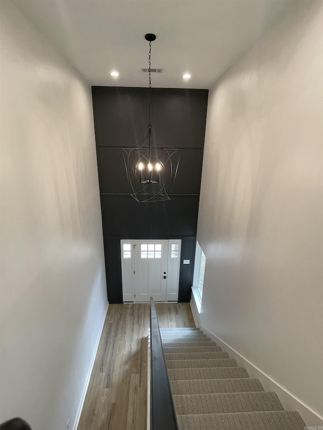 stairs featuring hardwood / wood-style floors