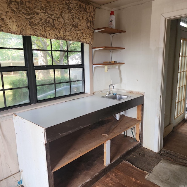 unfurnished dining area featuring sink and dark wood-type flooring